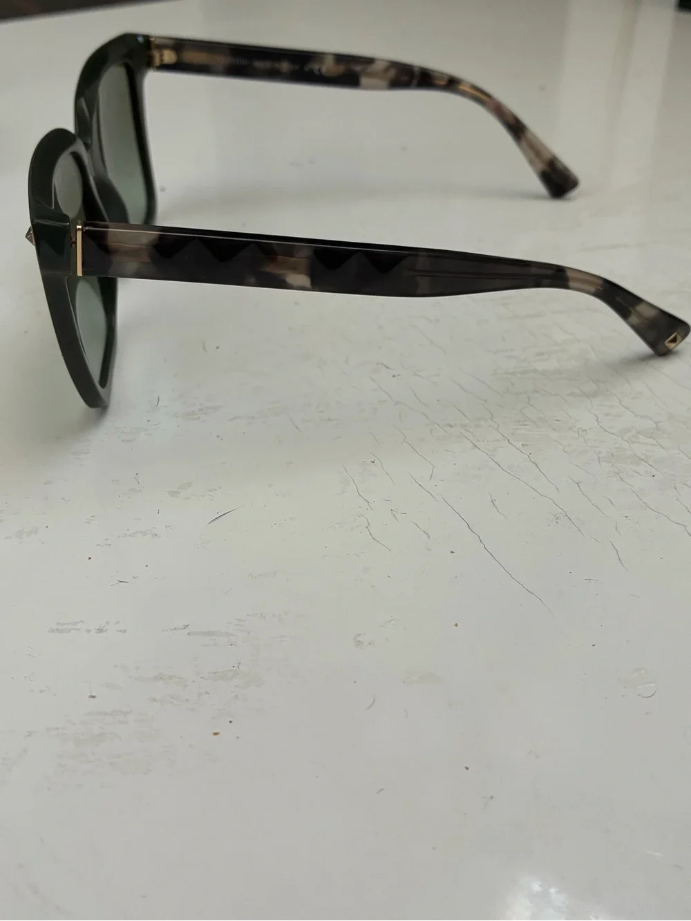 Valentino tortioshell sunglasses w a green lense and signature rockstuds on arms